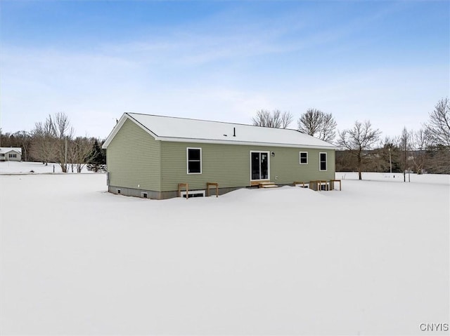 view of snow covered rear of property