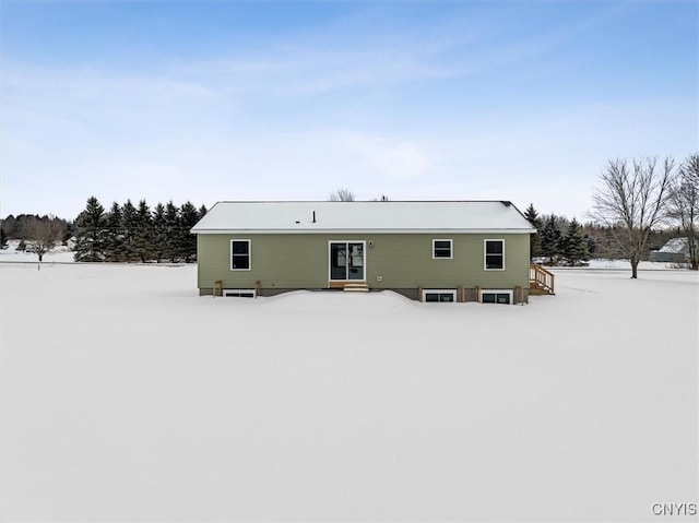 view of snow covered rear of property