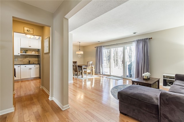 living room with light hardwood / wood-style floors and a textured ceiling