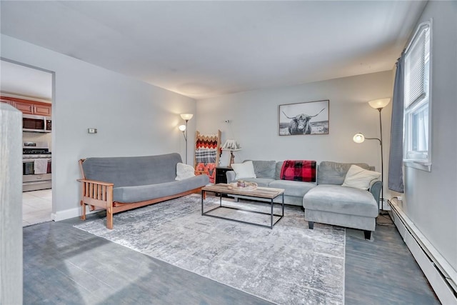 living room with dark hardwood / wood-style flooring and a baseboard heating unit