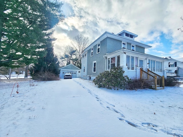 view of front of property featuring a garage and an outdoor structure