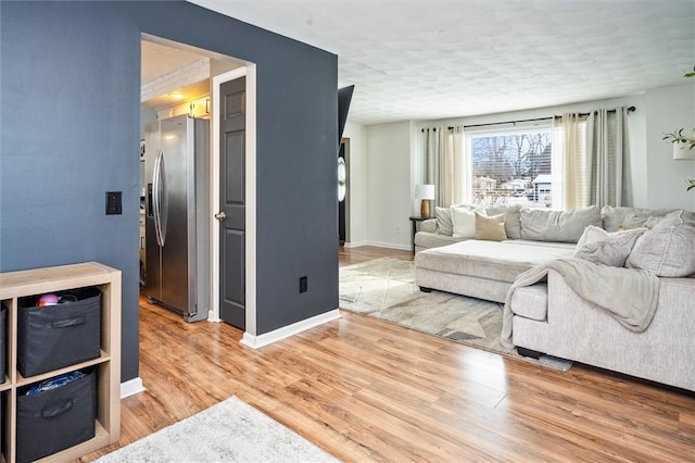 living room with wood-type flooring and a textured ceiling