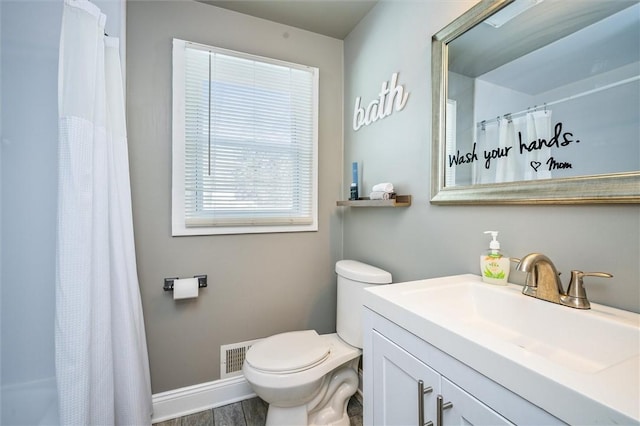 bathroom featuring vanity, wood-type flooring, curtained shower, and toilet