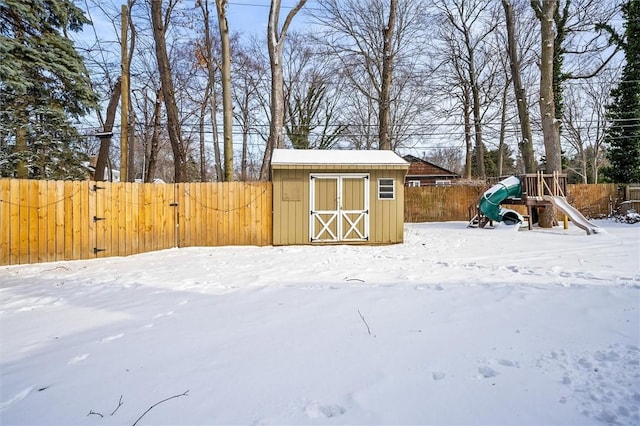 snow covered structure featuring a playground