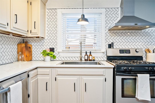 kitchen with sink, extractor fan, hanging light fixtures, appliances with stainless steel finishes, and decorative backsplash