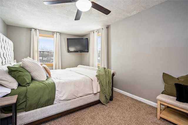 carpeted bedroom featuring a textured ceiling and ceiling fan