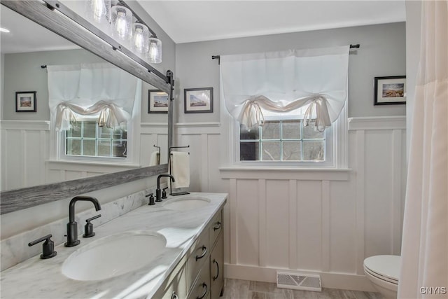 bathroom featuring vanity and toilet