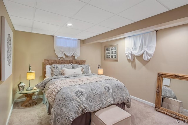 carpeted bedroom with a paneled ceiling