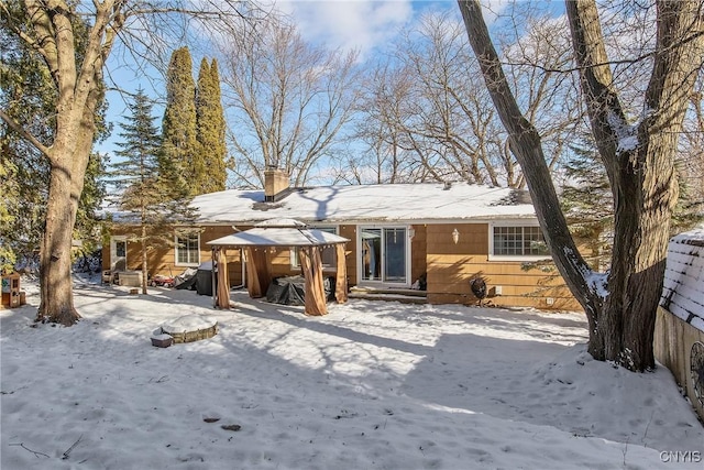 snow covered house with a gazebo