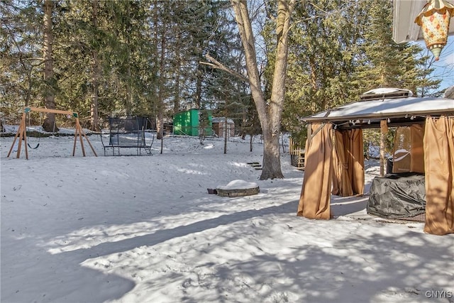 snowy yard with a trampoline