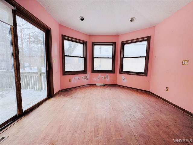 empty room with light wood-style floors and baseboards