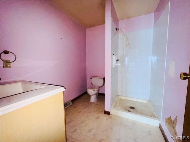 bathroom with baseboards, toilet, tile patterned floors, vanity, and a shower stall