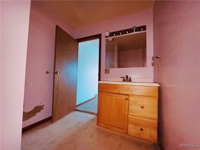 bathroom featuring baseboards and vanity