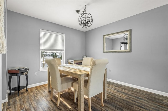 dining space with an inviting chandelier and dark hardwood / wood-style floors