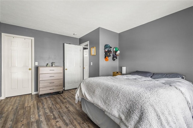 bedroom with dark hardwood / wood-style floors