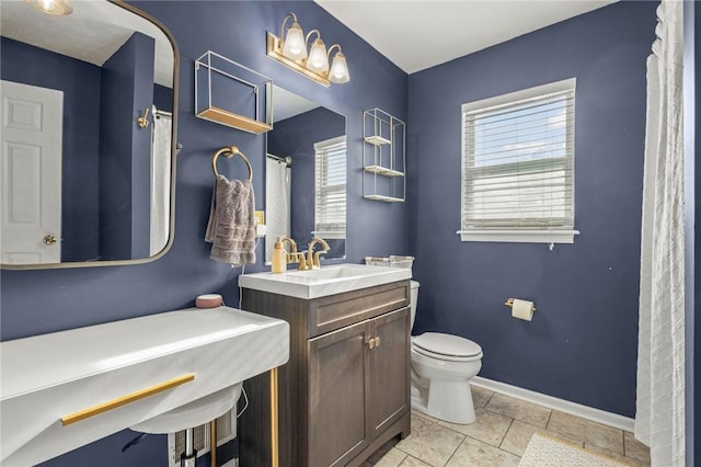 bathroom featuring tile patterned floors, toilet, and vanity