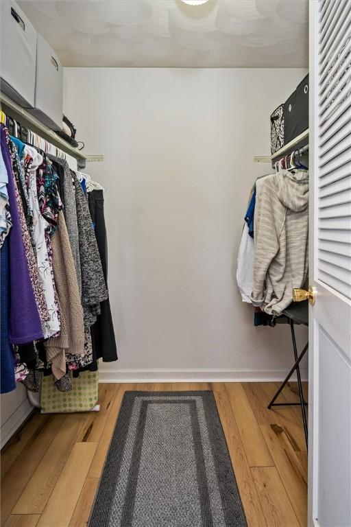 spacious closet featuring hardwood / wood-style floors