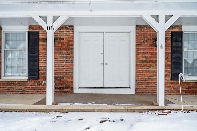 view of snow covered property entrance