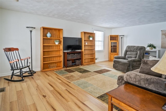 living room with hardwood / wood-style floors and a textured ceiling