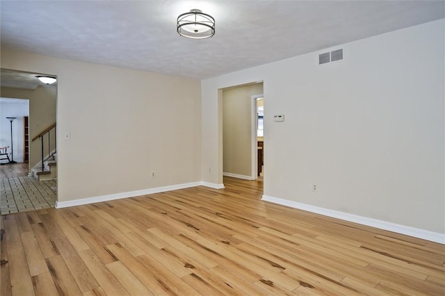 spare room featuring light hardwood / wood-style flooring