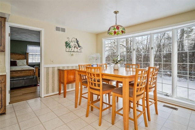 dining space featuring light tile patterned floors