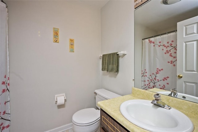 bathroom featuring vanity, curtained shower, and toilet