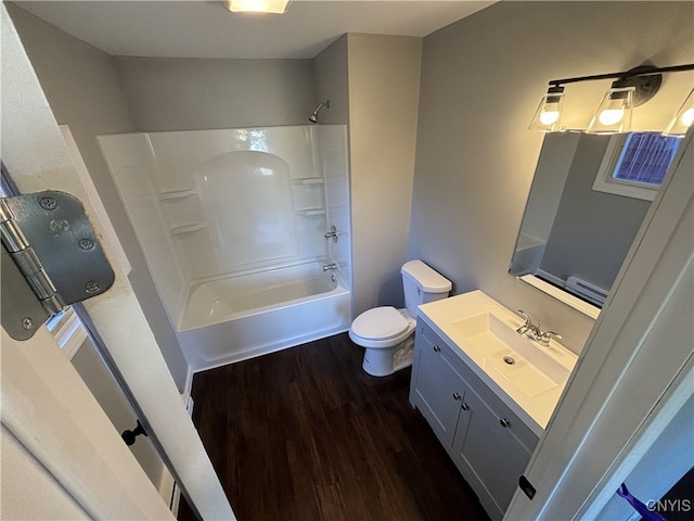 full bathroom with vanity, toilet, tub / shower combination, and hardwood / wood-style floors