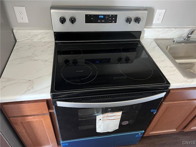 interior details featuring sink and range with electric stovetop