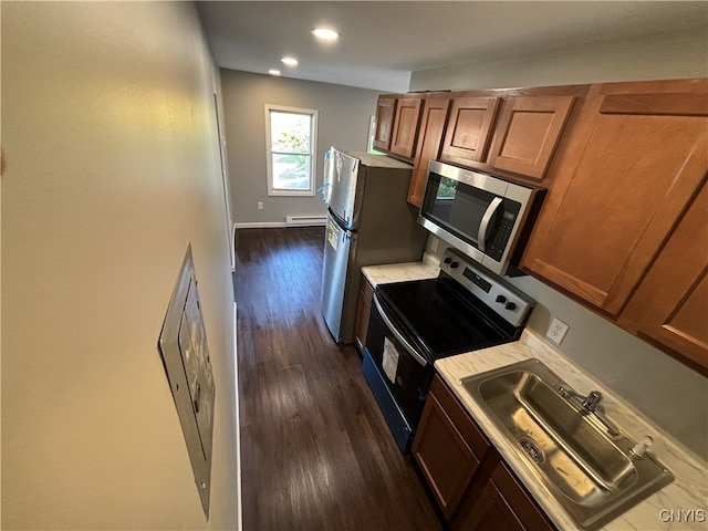 kitchen featuring dark wood-type flooring, stainless steel appliances, sink, and a baseboard heating unit