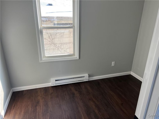 empty room with baseboard heating, plenty of natural light, and dark hardwood / wood-style floors