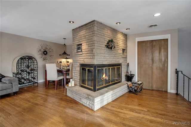 living room with a fireplace and hardwood / wood-style floors