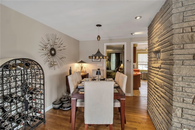 dining space with wood-type flooring