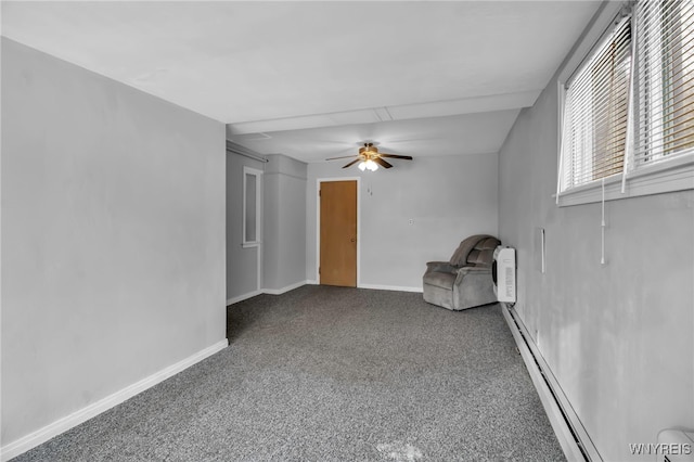 unfurnished room with ceiling fan, a wall mounted air conditioner, and a baseboard heating unit