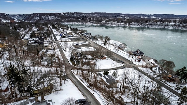 snowy aerial view with a water view