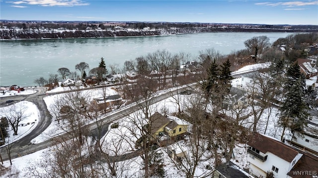 snowy aerial view featuring a water view