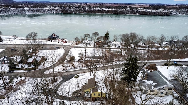 snowy aerial view featuring a water view