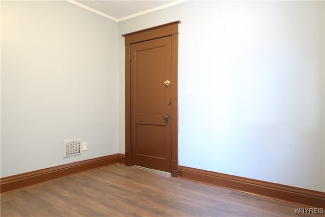 unfurnished room with wood-type flooring and crown molding