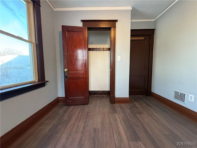 unfurnished bedroom featuring crown molding and dark hardwood / wood-style flooring