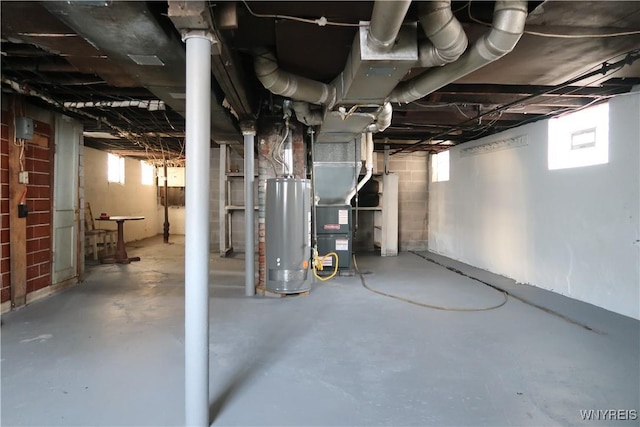 basement featuring heating unit and water heater