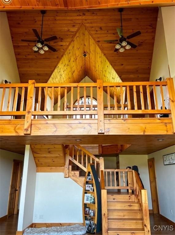 staircase featuring ceiling fan, high vaulted ceiling, and wooden ceiling