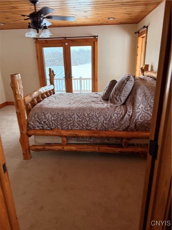 bedroom featuring access to exterior, wood ceiling, and carpet floors