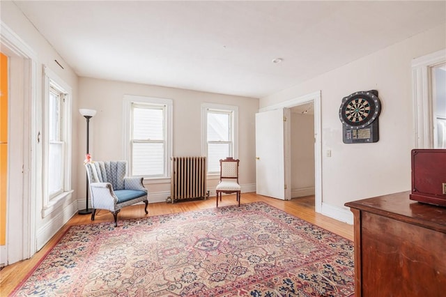 living area with radiator and light hardwood / wood-style floors