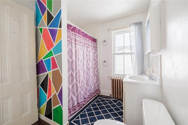 bathroom featuring toilet, radiator heating unit, vanity, and a shower with curtain