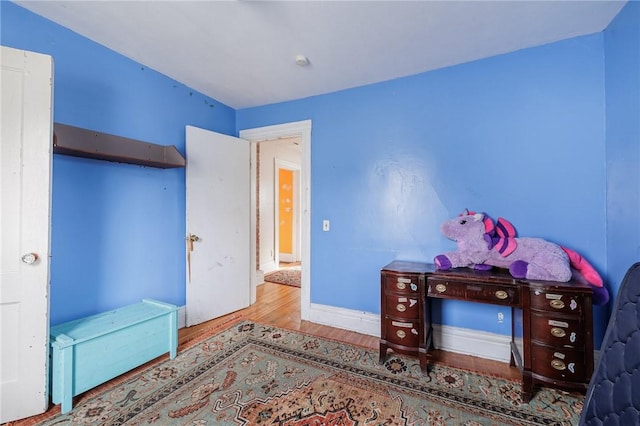 bedroom with hardwood / wood-style floors