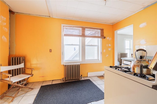 kitchen featuring radiator and light tile patterned floors