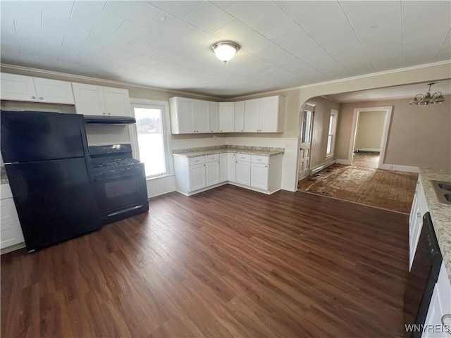 kitchen with white cabinetry, dark hardwood / wood-style floors, crown molding, and black appliances