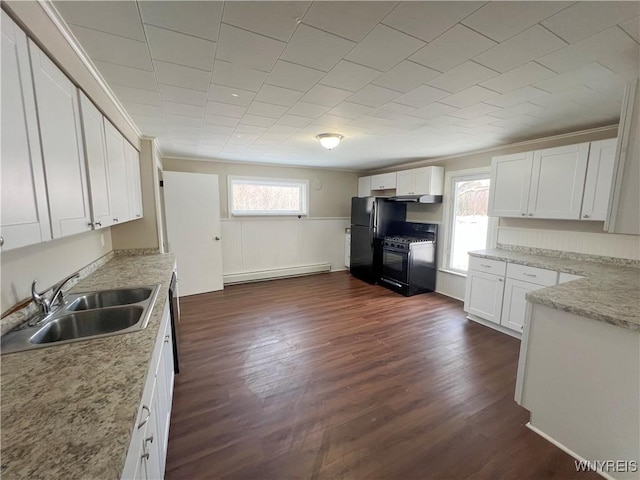 kitchen featuring dark hardwood / wood-style floors, a baseboard radiator, sink, white cabinets, and black appliances