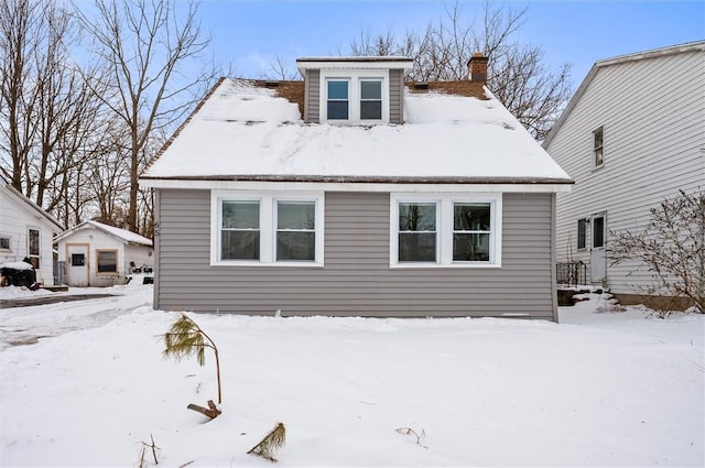 view of snow covered back of property