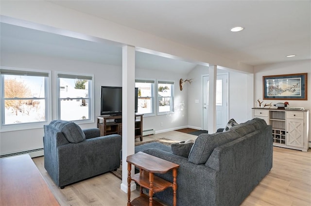 living room featuring plenty of natural light, a baseboard radiator, and light wood-type flooring