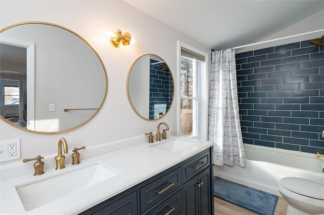 full bathroom with vanity, shower / tub combo, and toilet